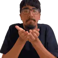 a man with glasses and a beard holds his hands together in front of his face
