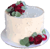 a white cake with roses and pearls on top