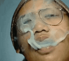 a close up of a person wearing glasses smoking