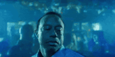 a man with his eyes closed in a dark room