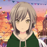 a girl in a green hoodie is standing in front of a roller coaster .