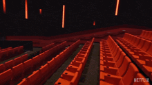 an empty movie theater with a netflix logo on the screen