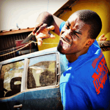 a man wearing a blue shirt that says ' freedom ' on it