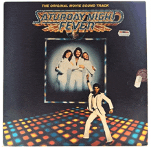 a poster for saturday night fever shows a man dancing on a disco floor