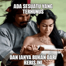 a man is holding a woman in his arms with the caption " ada sesuatu yang terhunus dan inya bukan dari keris ini