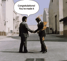 two men shake hands with a congratulations speech bubble above them