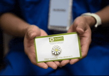 a person holding a card that says the daisy