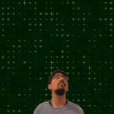 a man stands in front of a green background with the number 25