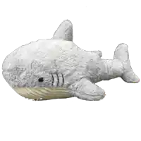 a stuffed shark with a white tail is laying on a white background