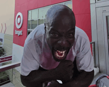 a man in a white shirt is standing in front of a target store