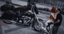 a man and woman are kissing in front of a motorcycle