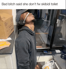 a man wearing a headset is leaning against a wall with the caption bad bitch said