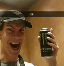 a man is holding a can of monster energy drink in his hand