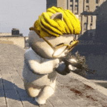 a cat wearing a yellow hat holds a gun