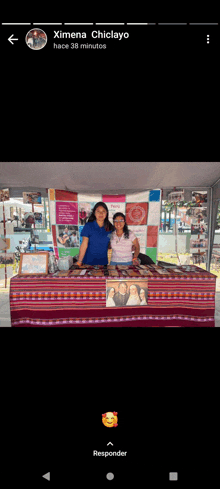 two women standing in front of a table with the name ximena chiclayo