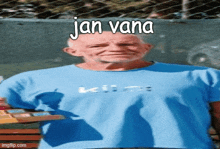 a man wearing a blue shirt with the name jan vana written on it