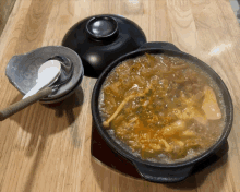 a pot of food with a spoon in it on a table