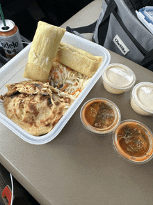 a container of food sits on a table next to a bag that says ole hike