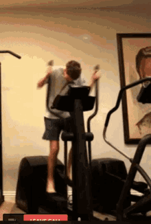 a man is jumping on an elliptical machine with a leave call button in the corner