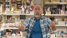 a man with a beard is standing in front of a store shelf with a sign that says no cheques accepted