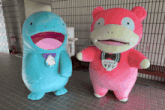 two stuffed animals one blue and one pink are standing next to each other and one of them has a name tag that says " yadon "