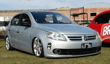 a silver vw car with a license plate that says hjy 331