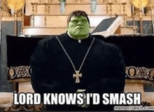 a priest with a green mask and a cross necklace is standing in front of a coffin in a church .