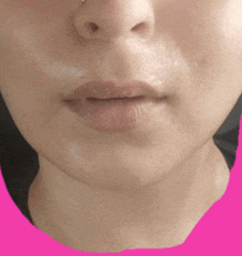 a close up of a woman 's face with a pink border around her mouth .