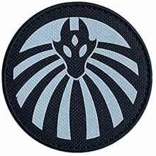 a black patch with a white eagle in a circle on it .