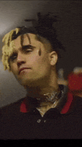 a close up of a man 's face with dreadlocks