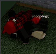 a snoopdogg laying on the ground with a brick wall in the background