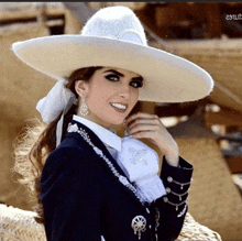 a woman wearing a white hat and a black jacket is smiling for the camera