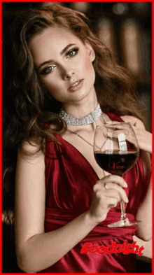 a woman in a red dress is holding a glass of wine with the words goodnight written on the bottom