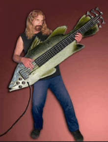 a man is playing a fish shaped bass guitar