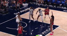 a basketball game is being played on a court with a vanda logo on the floor