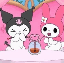 two cartoon characters , kuromi and my melody , are sitting next to each other at a table .