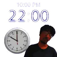 a man stands in front of a clock that says 2:00 pm