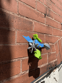 a brick wall with a toy plane attached to it