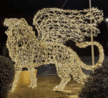 a statue of a lion made of christmas lights