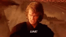 a man in a black shirt is screaming and saying `` liar ! '' .