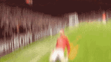 a blurred image of a soccer field with the word sport on the fence