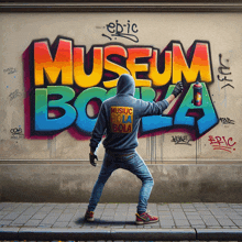 a man spray paints graffiti on a wall that reads museum bola