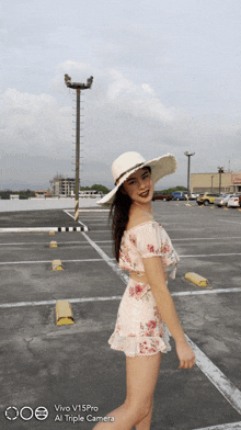 a woman wearing a white hat is standing in a parking lot with the words vivo v15pro at the bottom of the photo