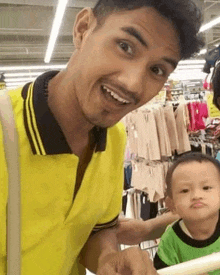 a man and a baby are standing next to each other in a store .