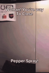 a sign that says woman you 're way to close pepper spray on it