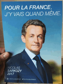 a man in a suit and tie is on a blue poster that says pour la france j'y vais quand meme