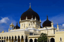 a large yellow building with a dome and a crescent moon on top