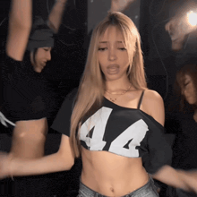 a woman wearing a crop top that says 44 on it