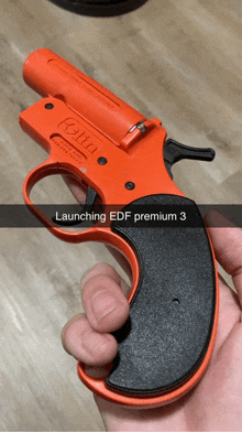 a person is holding a gun that says launching edf premium 3 on it