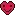 a pixel art of a red heart with a smiley face on it .